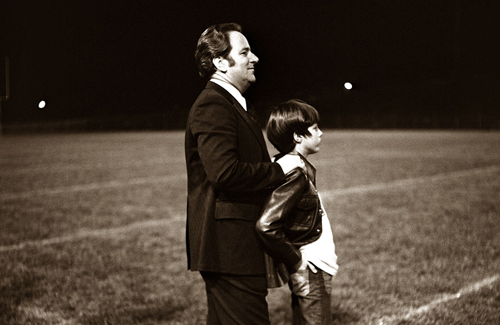 Jerry Falwell, Sr. and Jerry Falwell, Jr. watch a Liberty football game in 1974.