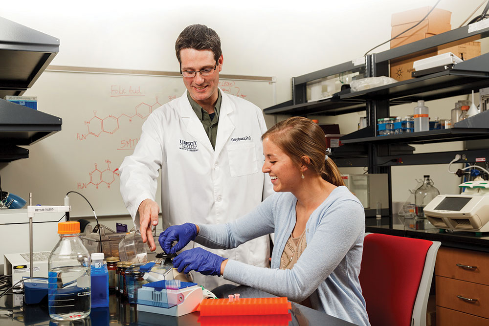 Dr. Gary Isaacs, associate professor of biology, and rising junior Caroline Roberts work on a nutritional study.